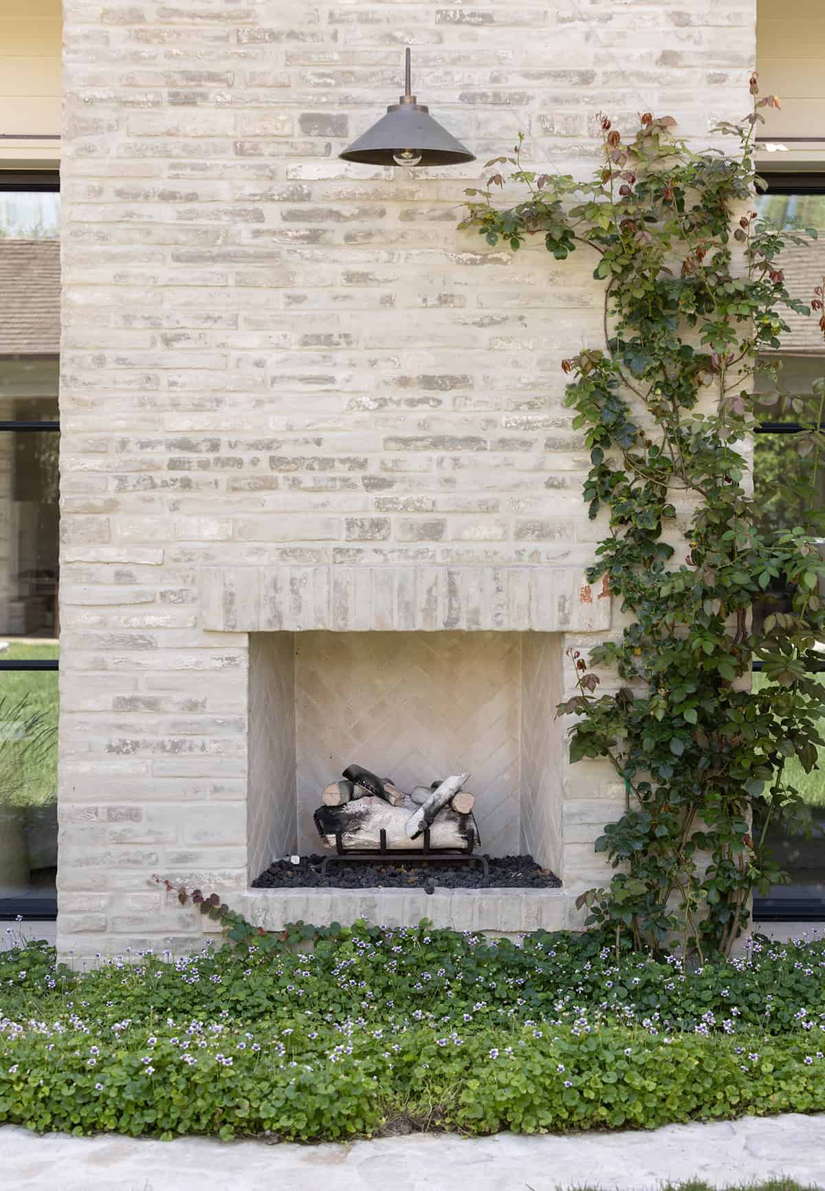 transitiional style home landscaping with a fireplace