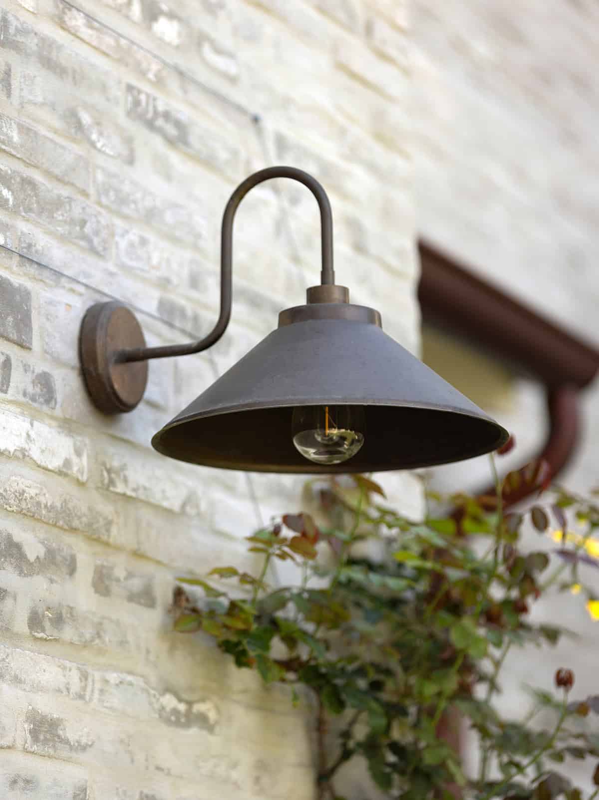 transitiional style home exterior gooseneck light detail