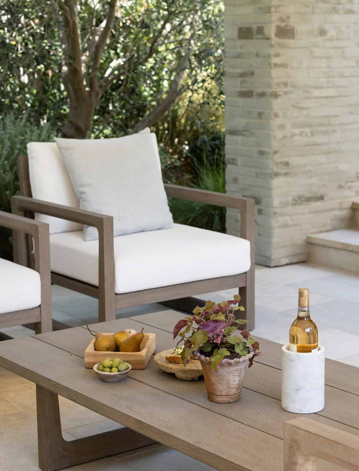 transitiional style home exterior covered patio with a coffee table and chairs