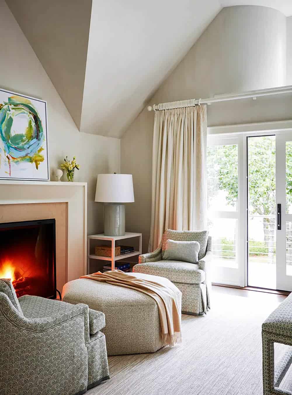 transitional style bedroom with a sitting area and fireplace