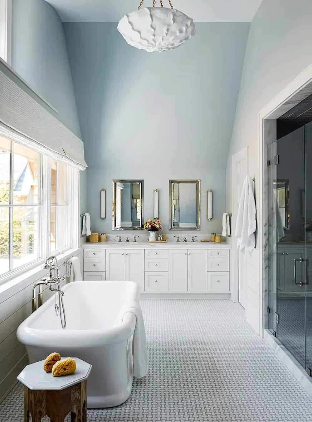 transitional style bathroom with a vanity and glass door shower, and freestanding tub