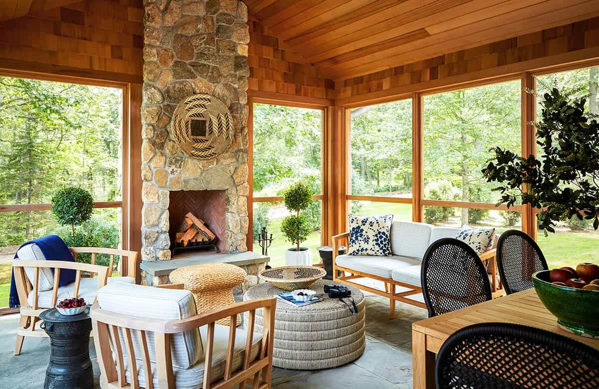 transitional style screened porch with a fireplace