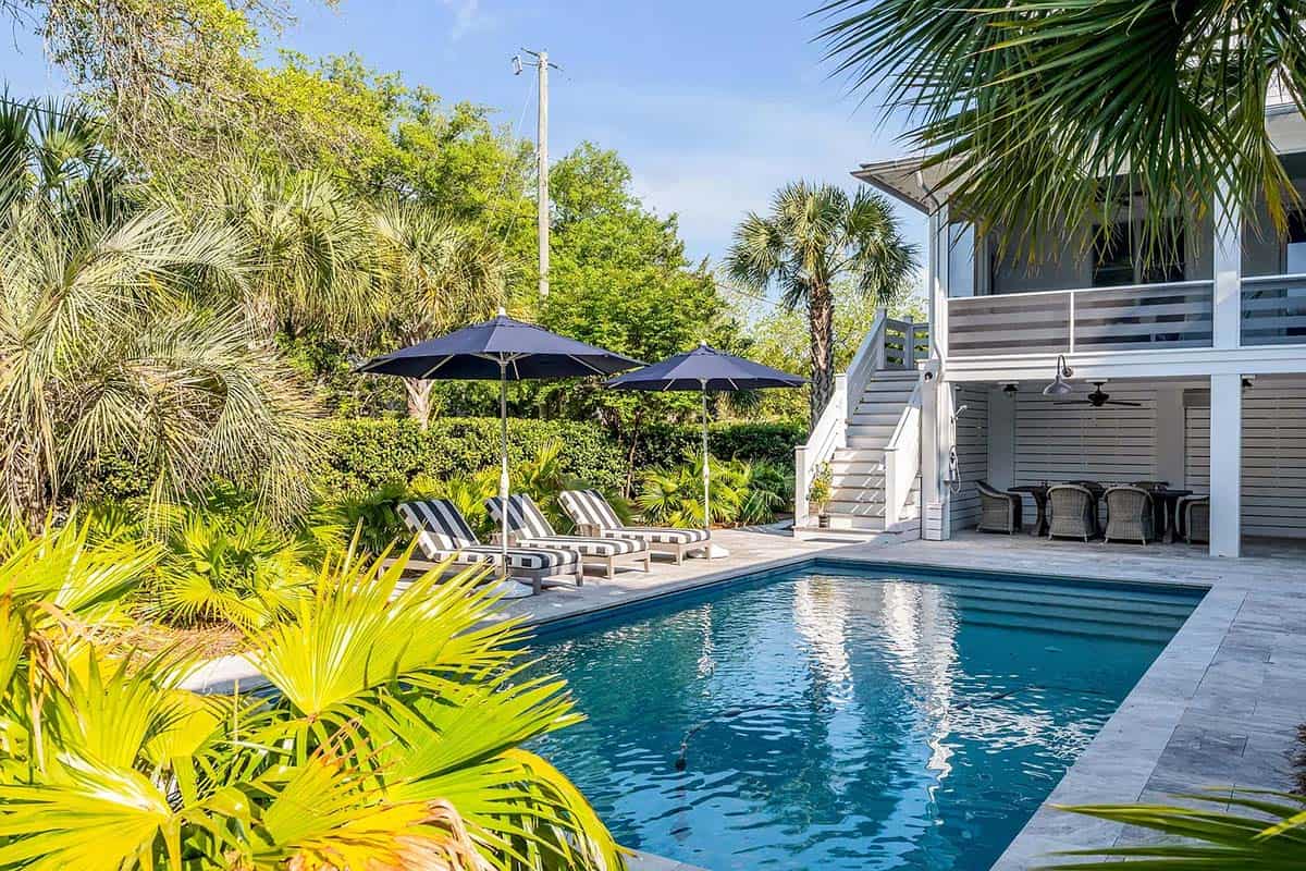 beach style house exterior with a pool