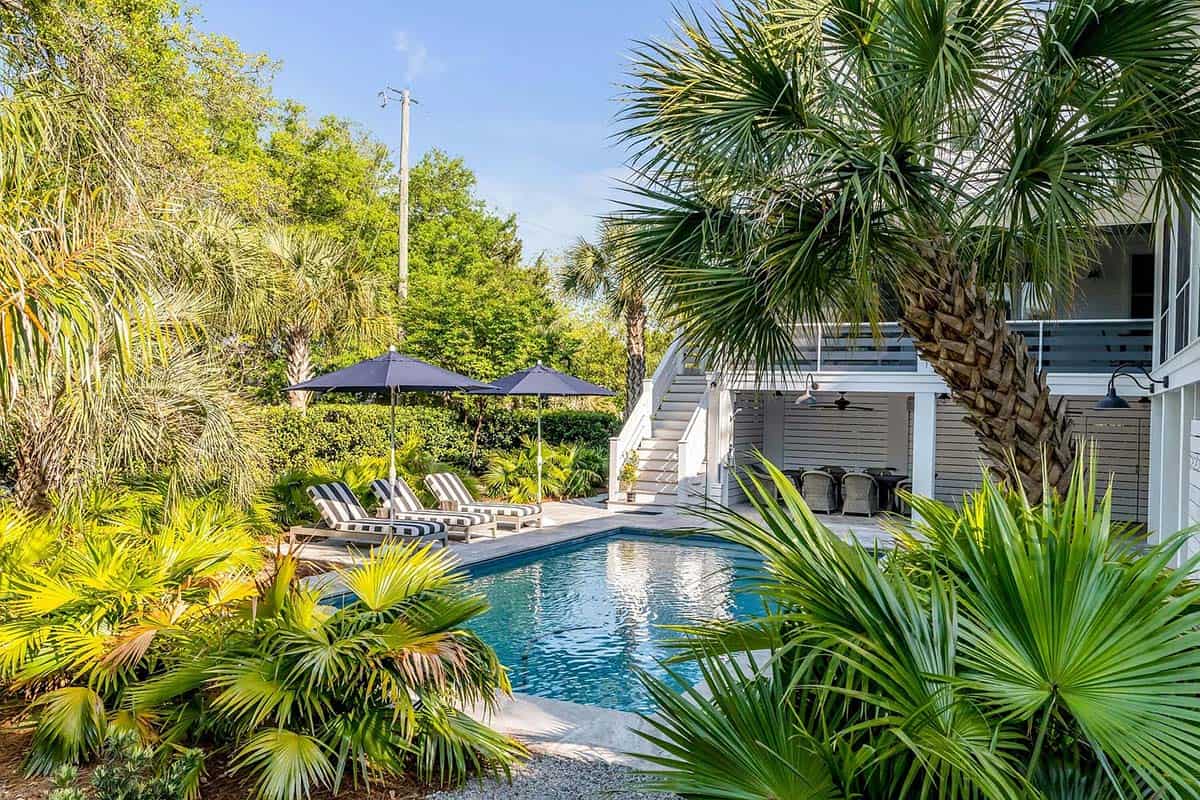 beach style house exterior with a pool