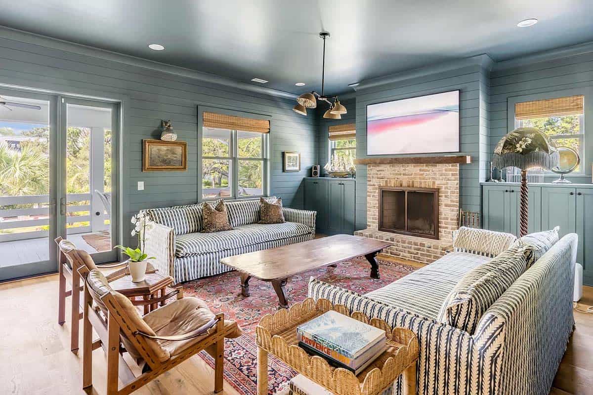 beach style family room with a fireplace