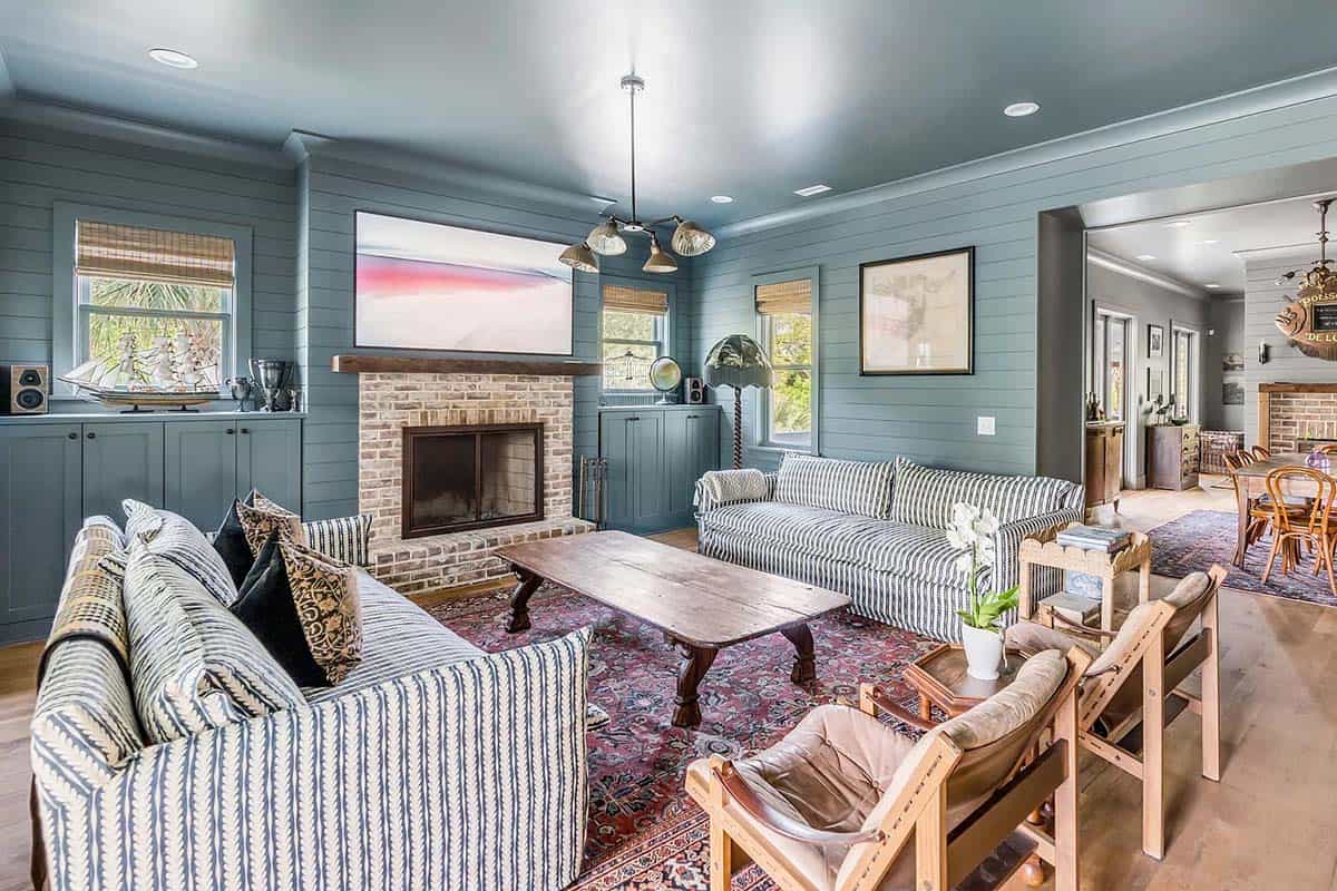 beach style family room with a fireplace