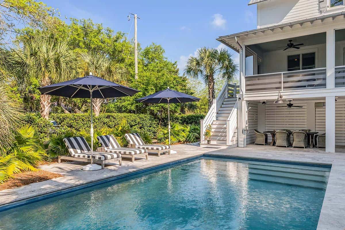 coastal style house exterior with a pool
