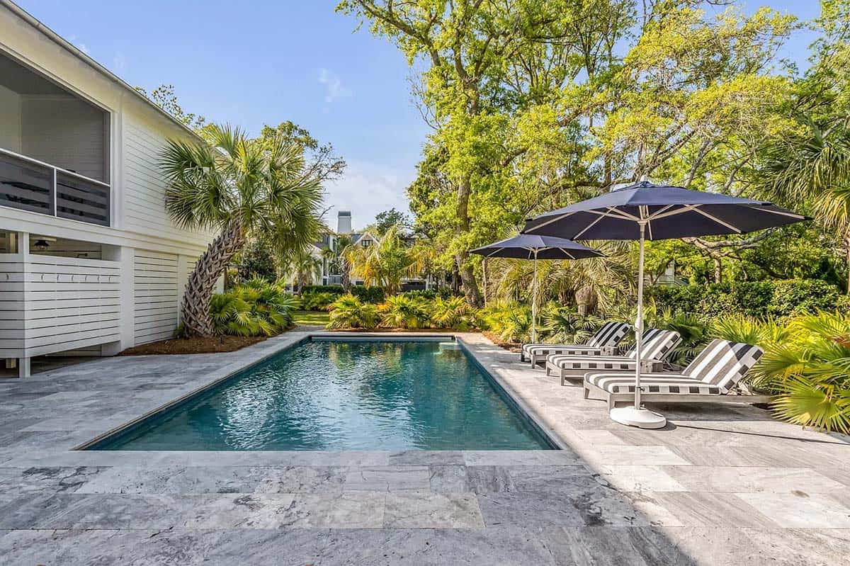 coastal style house exterior with a pool
