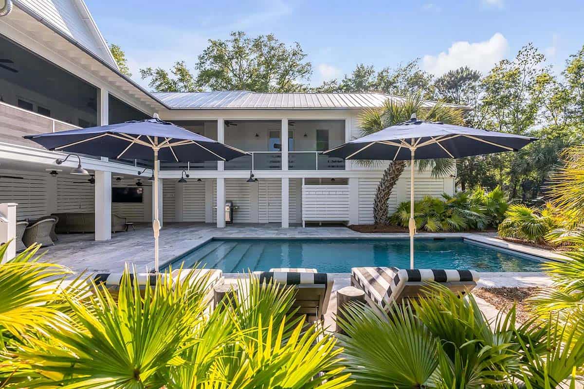 coastal style house exterior with a pool