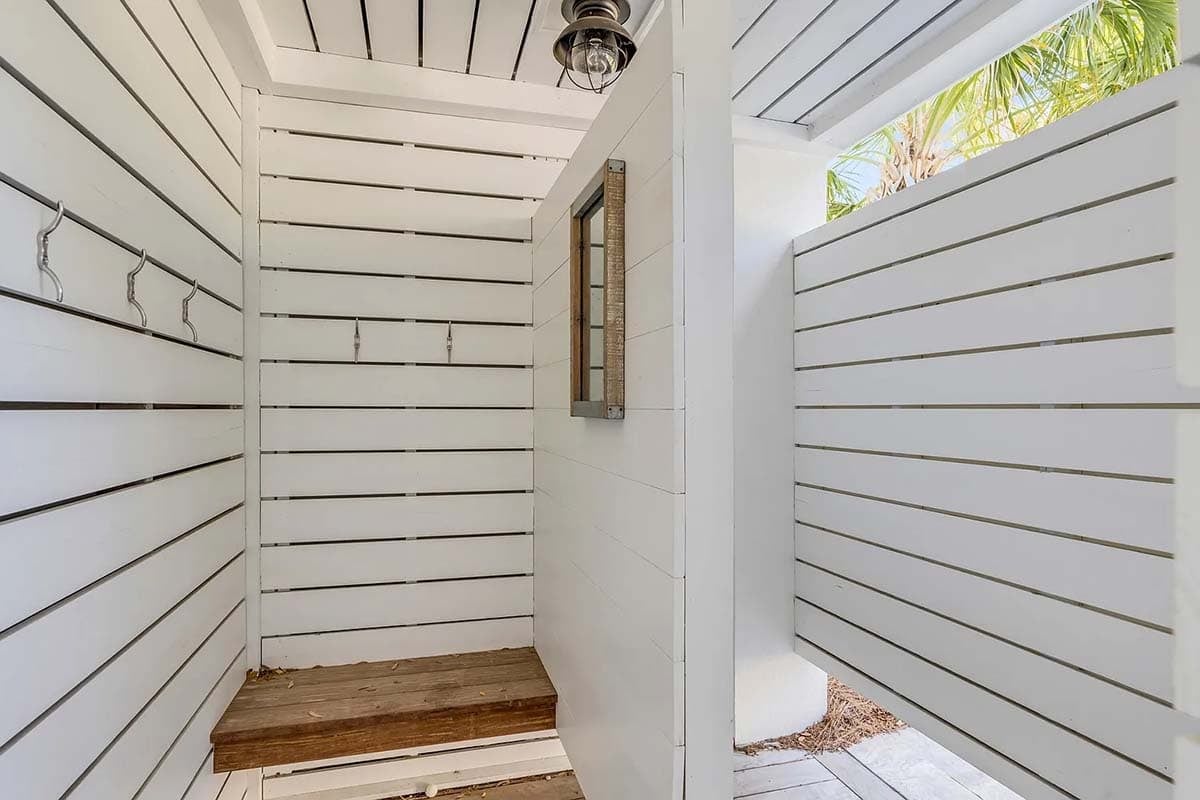 coastal style house exterior with an outdoor shower and changing room