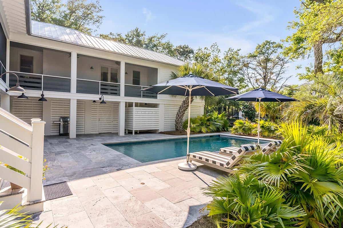 coastal style house exterior with a pool