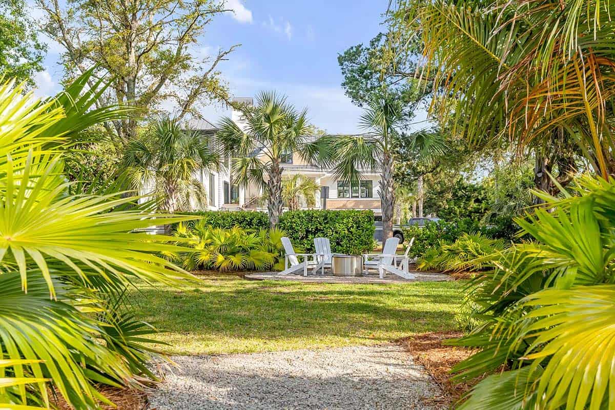 coastal style house exterior landscape view with a backyard firepit