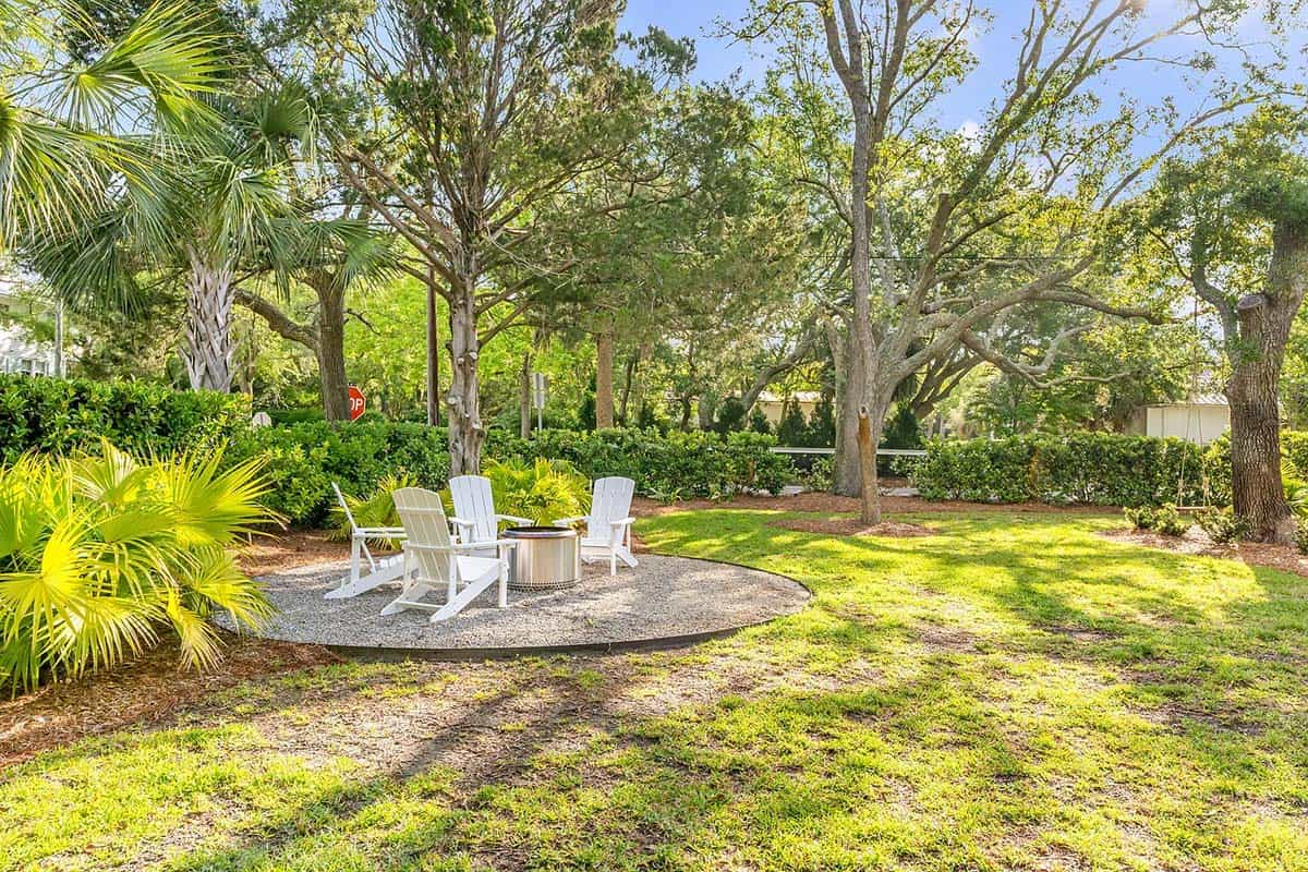 coastal style house exterior landscape view with a backyard firepit