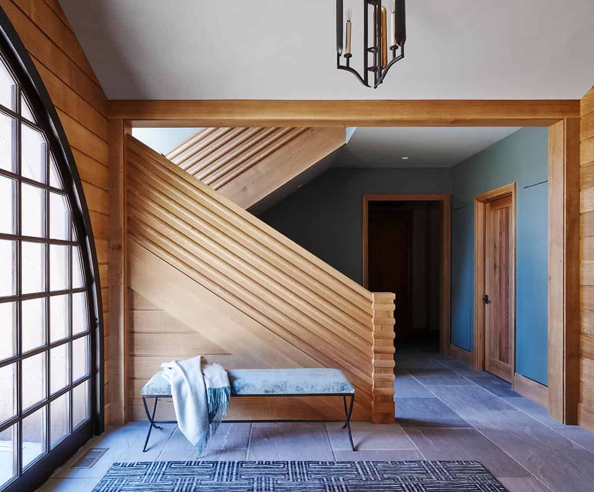 chalet-inspired lake house entry with a staircase