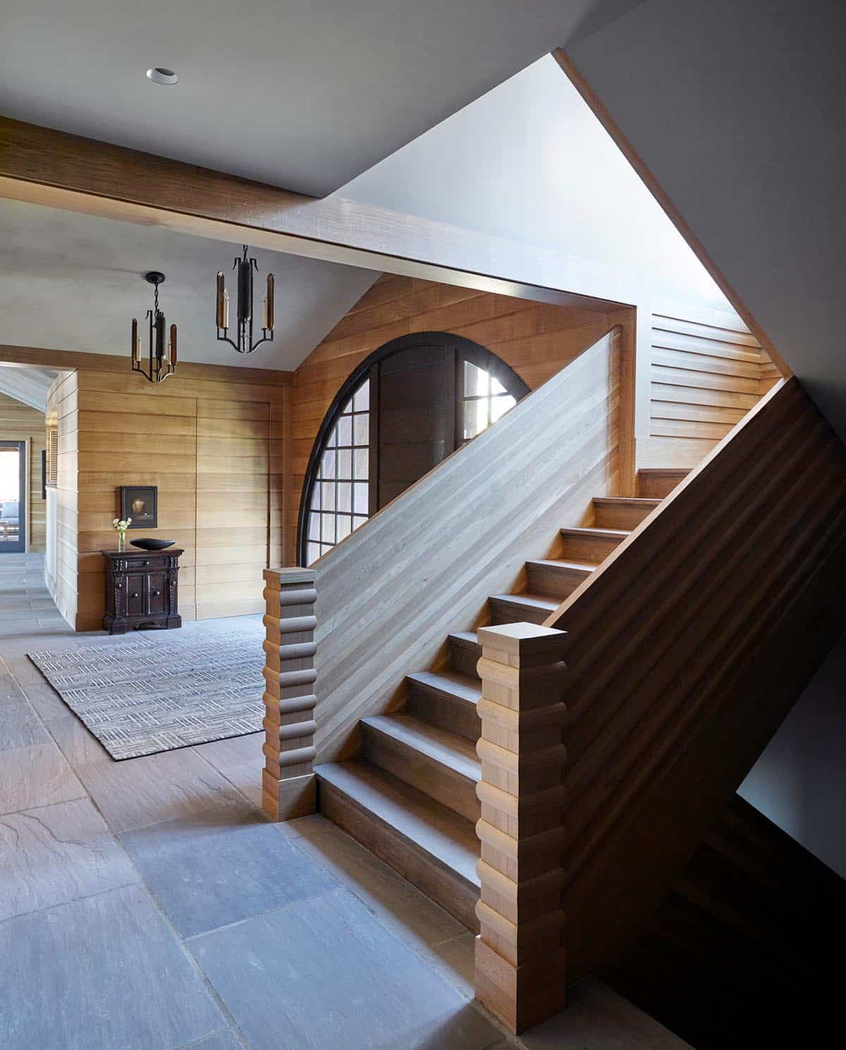 chalet-inspired lake house entry with a staircase