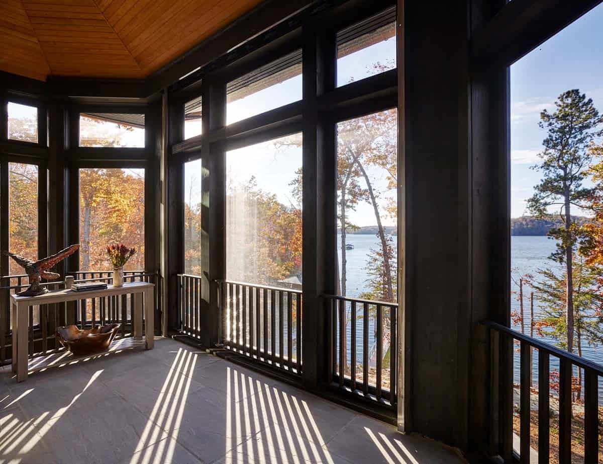 modern rustic screen porch with a lake view