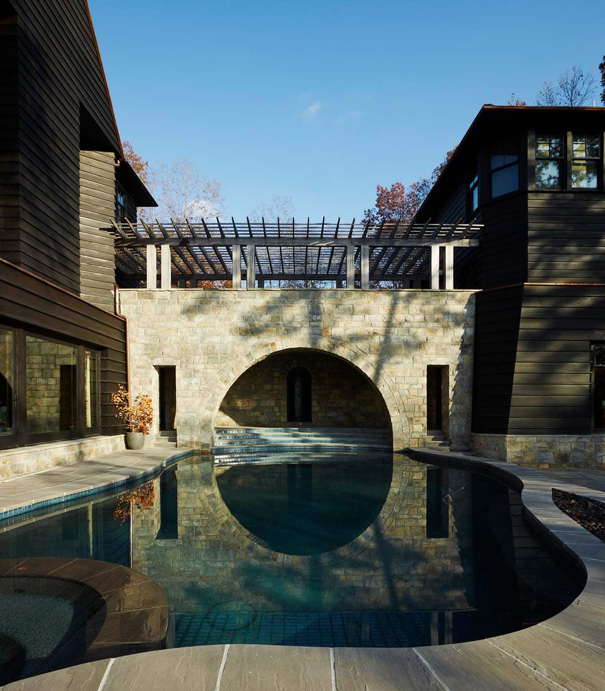 chalet-inspired lake house exterior with a pool