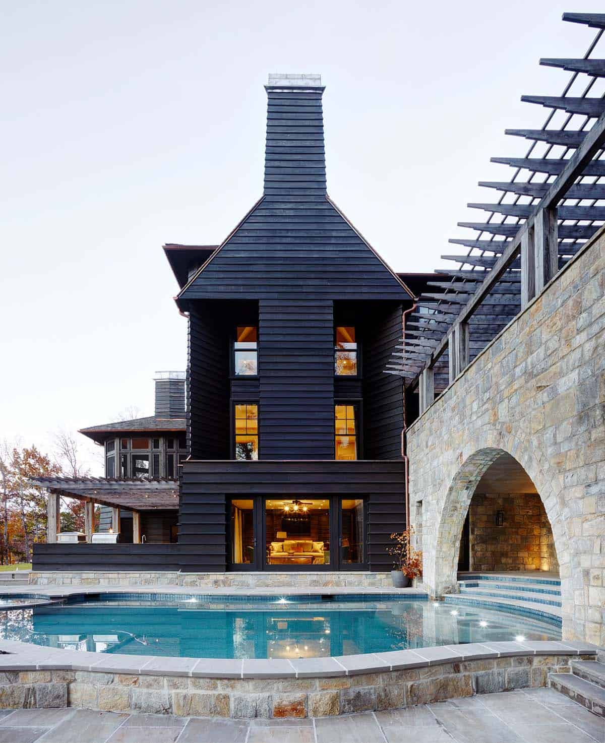 chalet-inspired lake house exterior with a pool