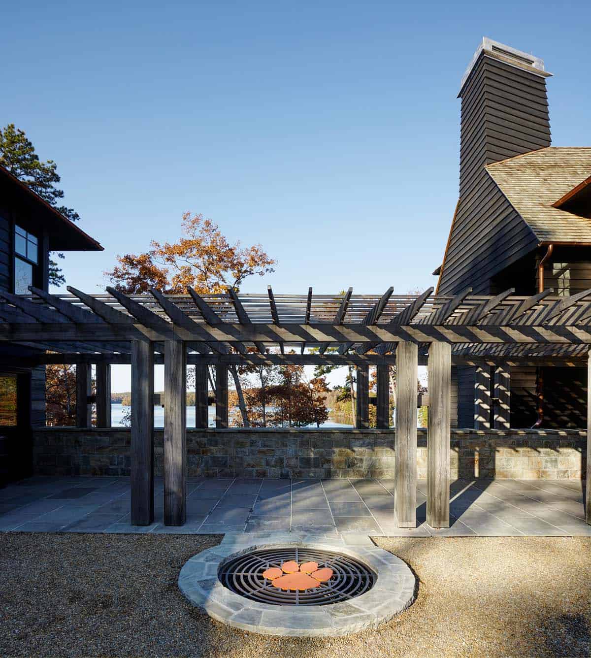 chalet-inspired lake house exterior with a fire pit
