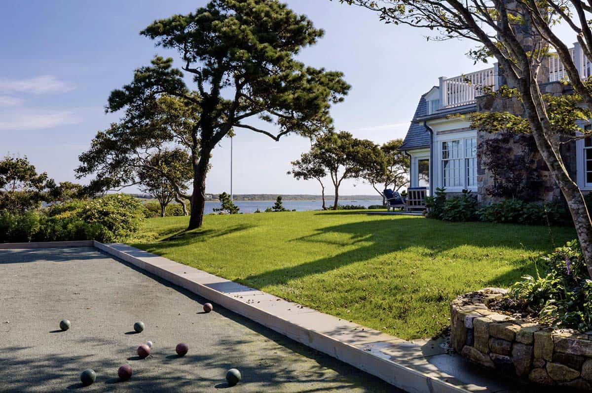 coastal gambrel shingle style home exterior with a boche ball court