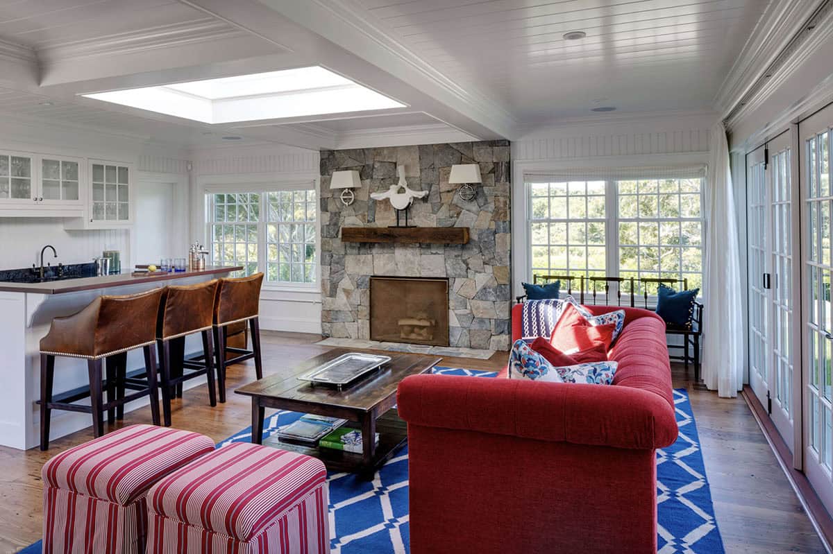 beach style family room with a fireplace