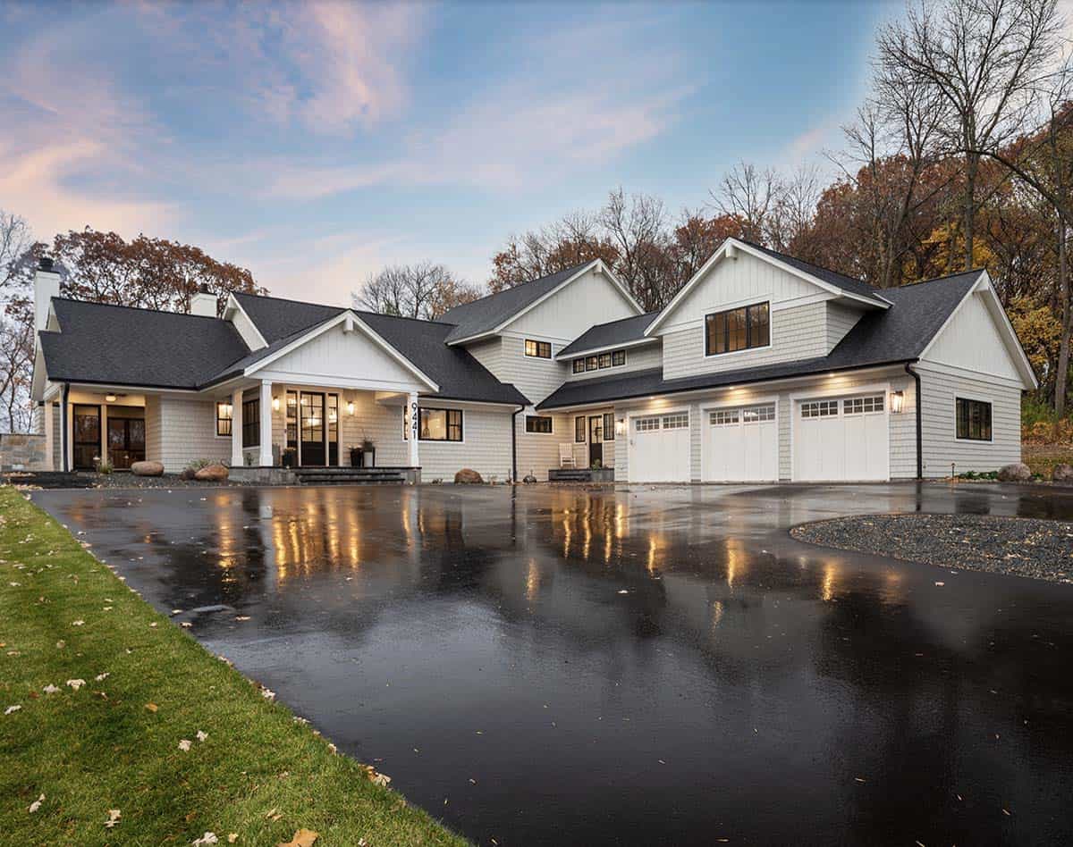 coastal style lake house exterior with a long driveway