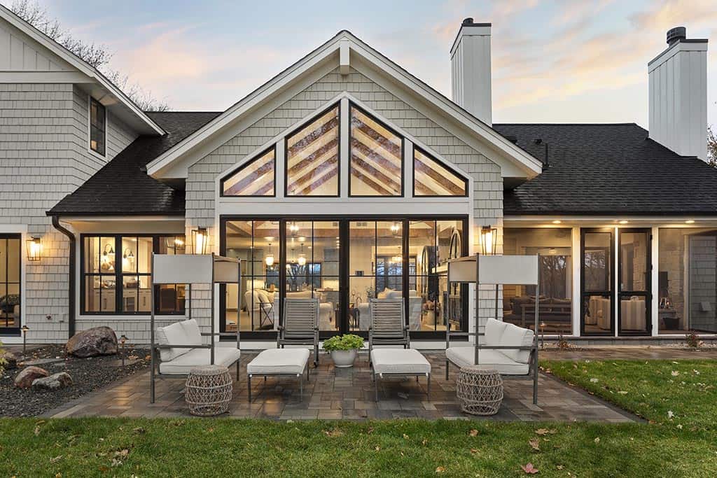 coastal style lake house exterior backyard with a patio and outdoor furniture