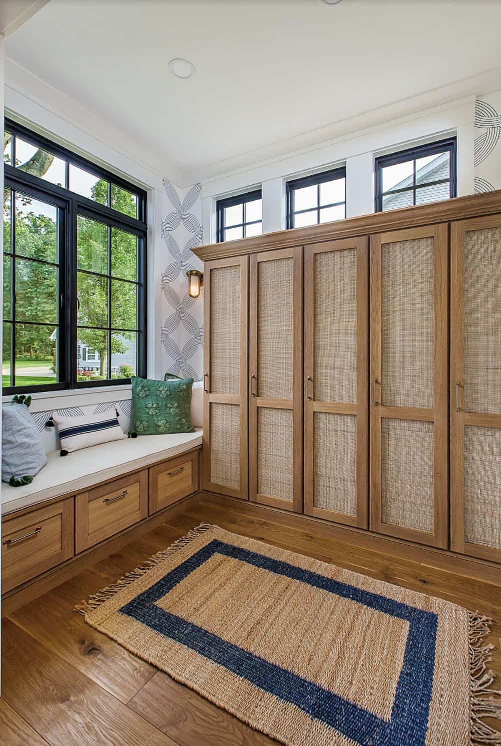 coastal style mudroom with a built-in window seat