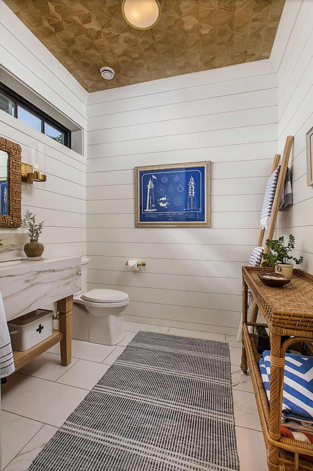 coastal style powder room with marble floor