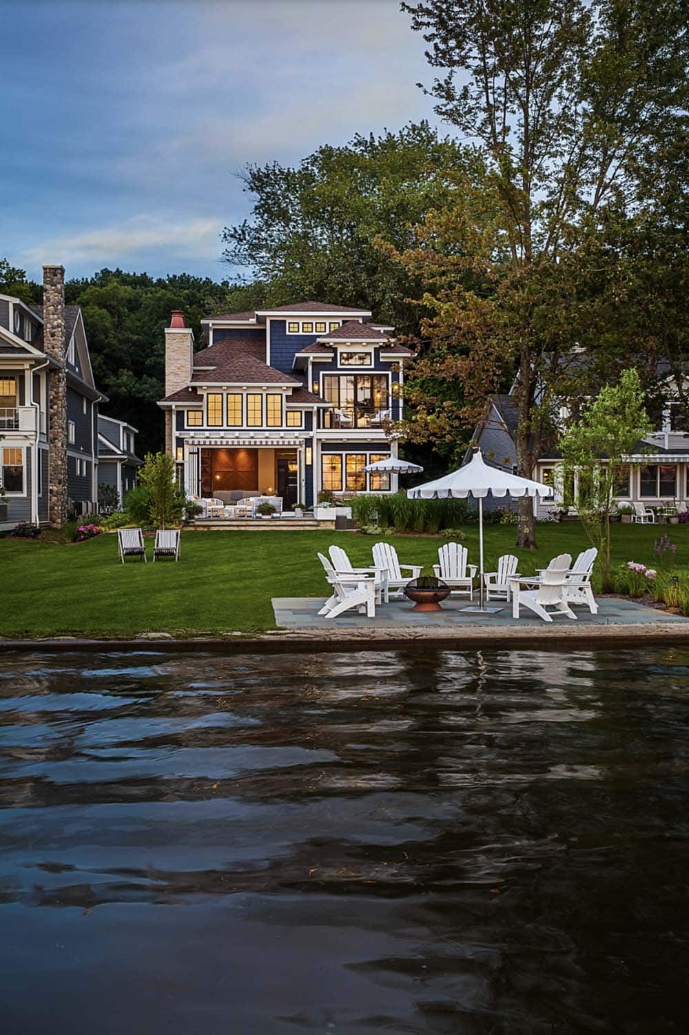 coastal style lake house backyard with a water view