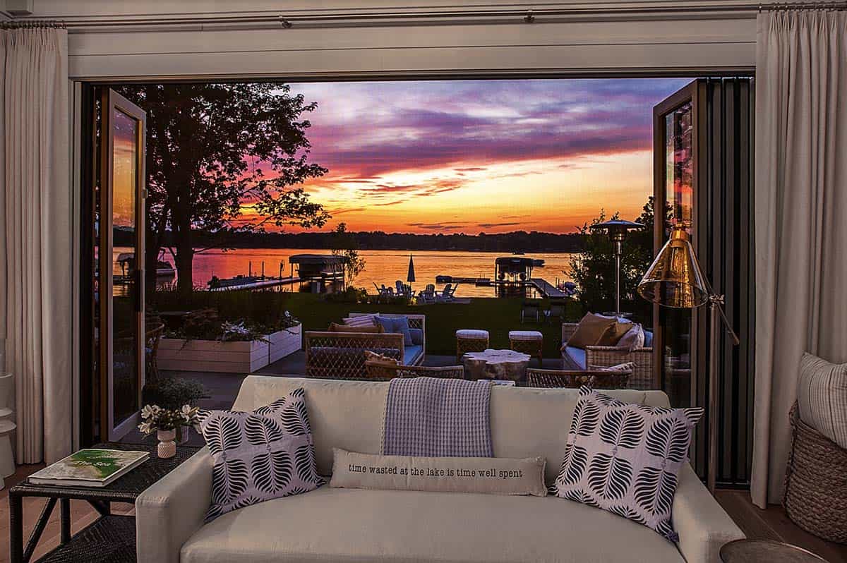 coastal style living room with a view of the lake at dusk