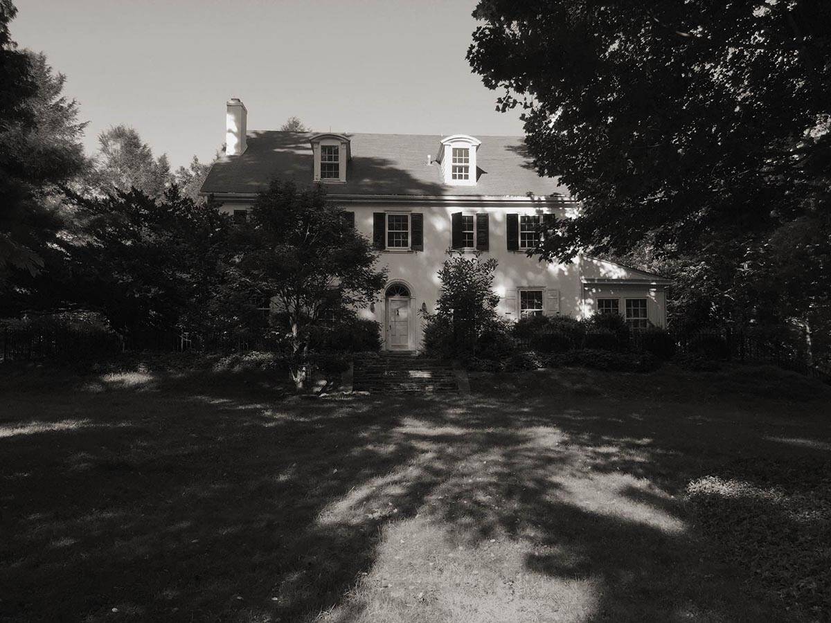 colonial-style farmhouse home exterior before the remodel