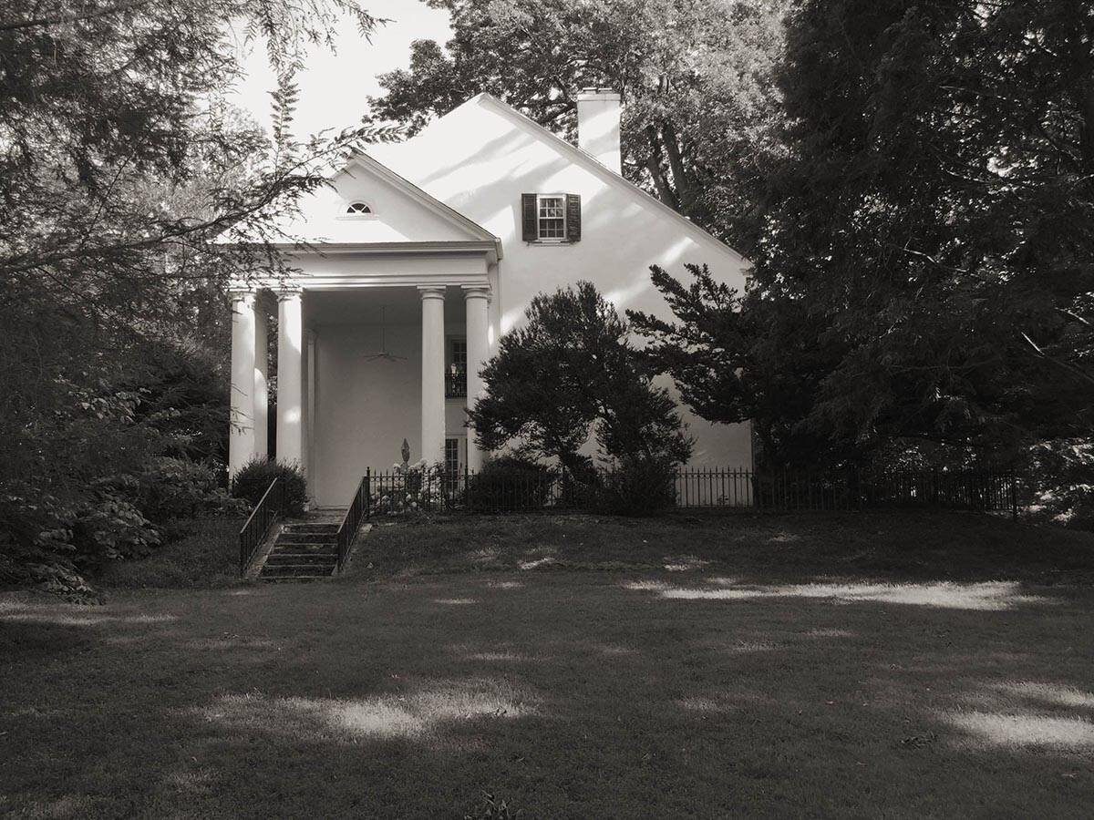 colonial-style farmhouse home exterior before the remodel