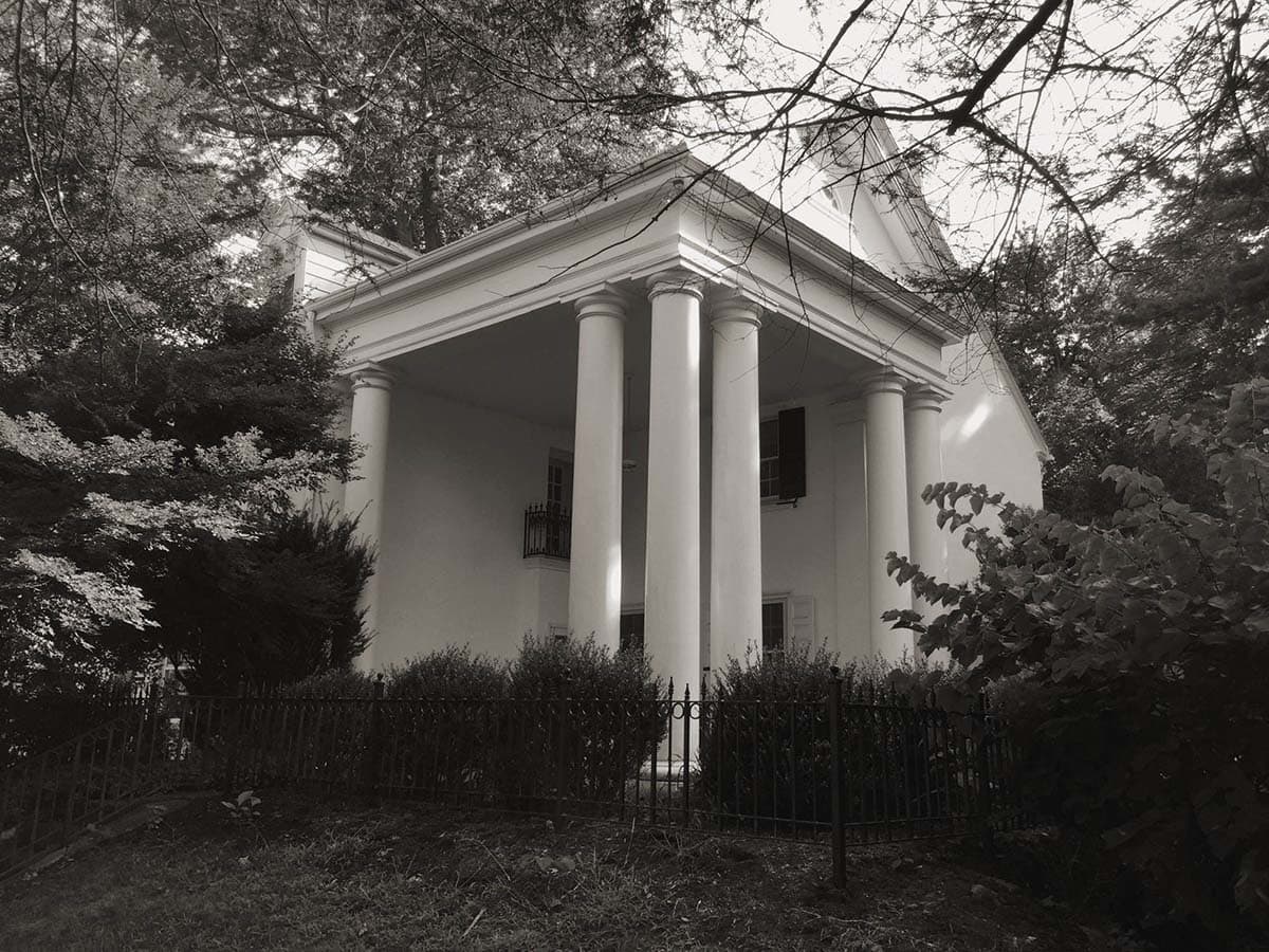 colonial-style farmhouse home exterior before the remodel