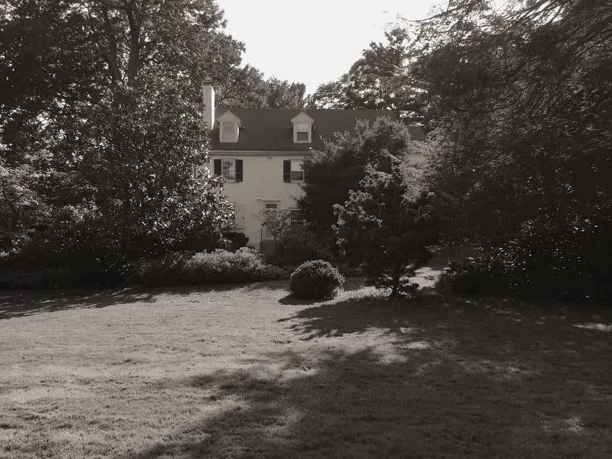 colonial-style farmhouse home exterior before the remodel