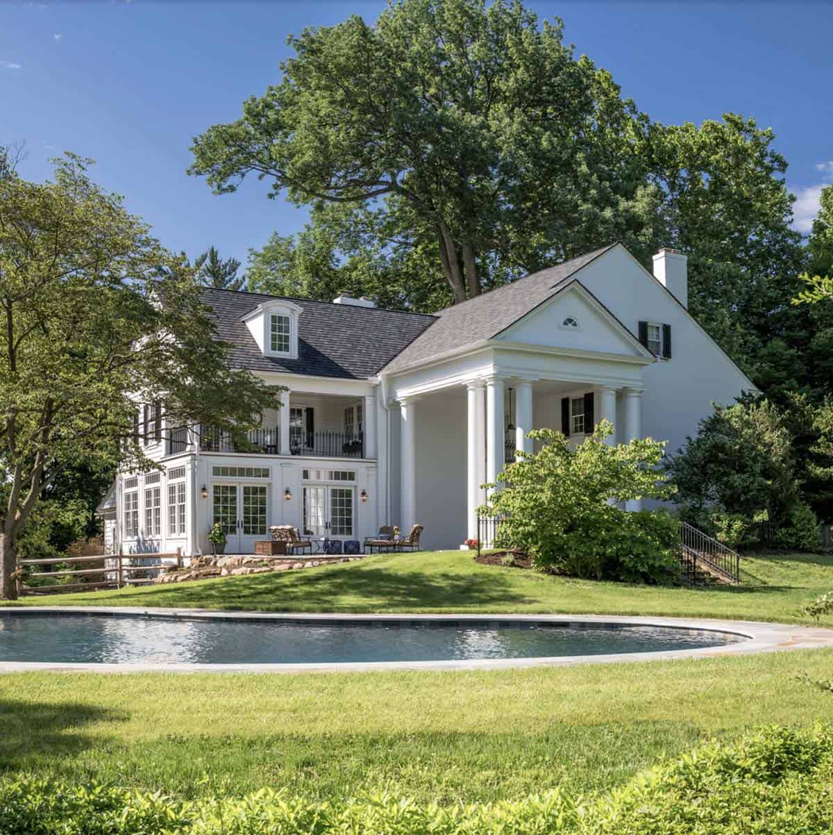 colonial-style farmhouse exterior backyard with a pool