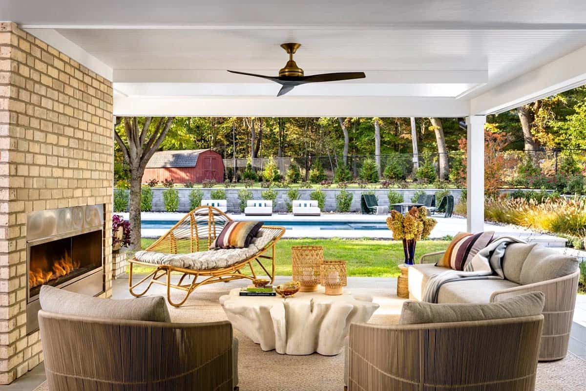 farmhouse style covered porch with a fireplace and outdoor furniture