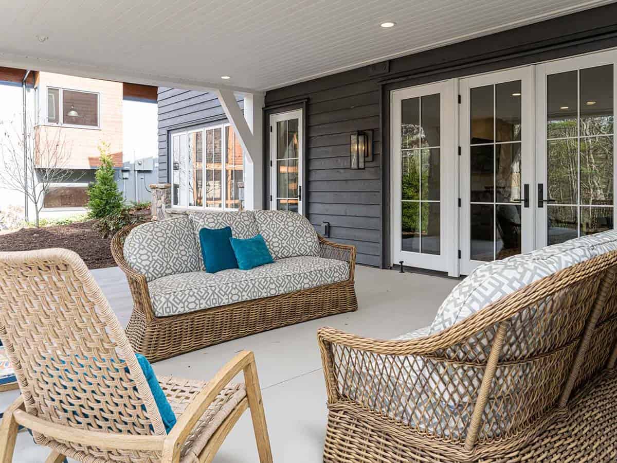 contemporary farmhouse style covered porch with outdoor furniture