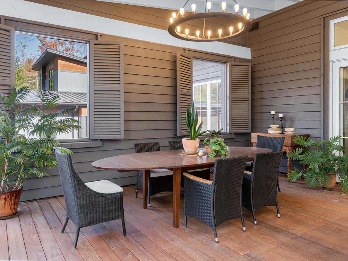 contemporary farmhouse style covered porch with alfresco dining