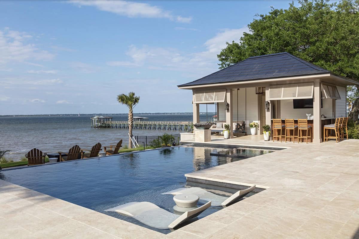 contemporary swimming pool with a pool house