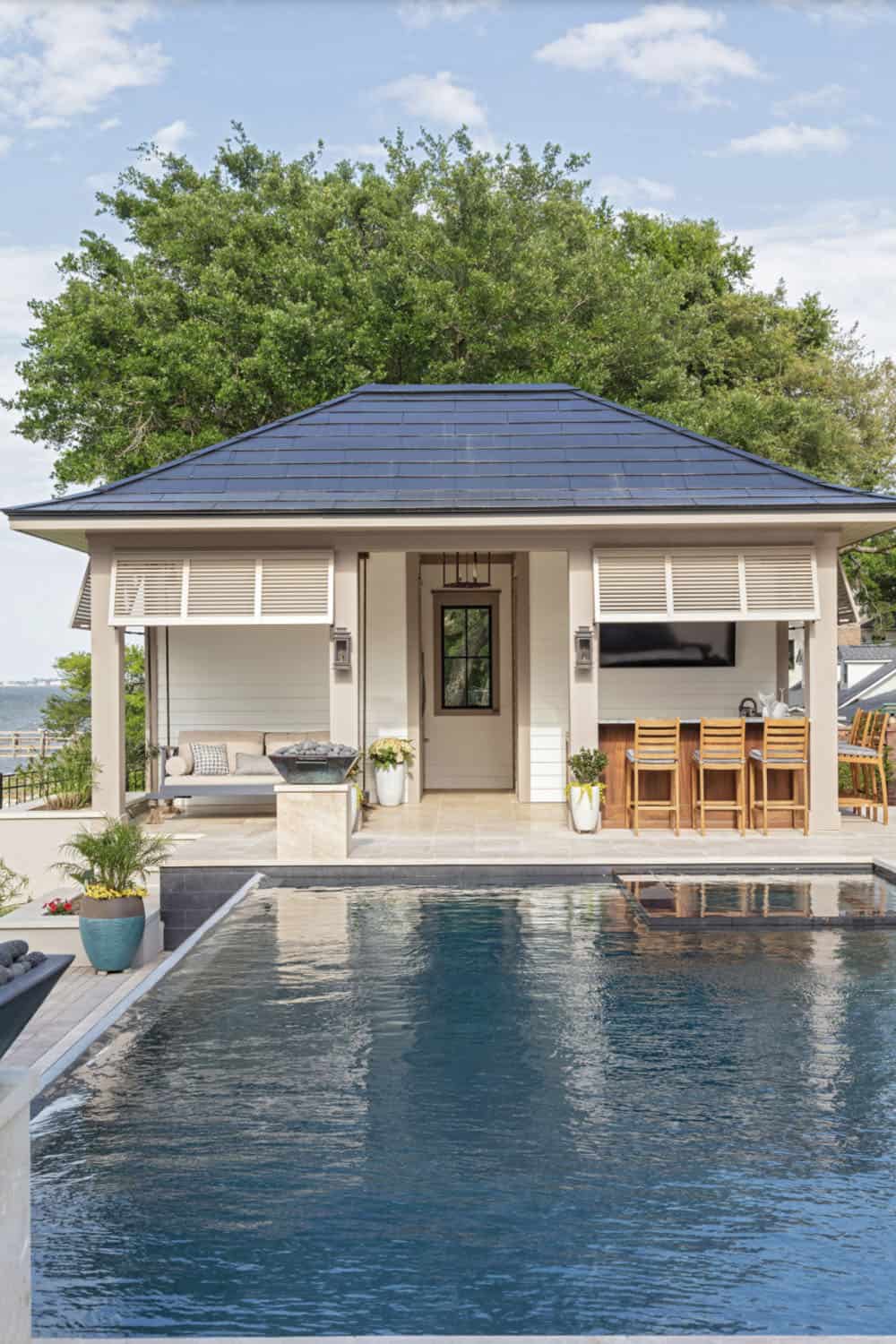 contemporary swimming pool with a pool house