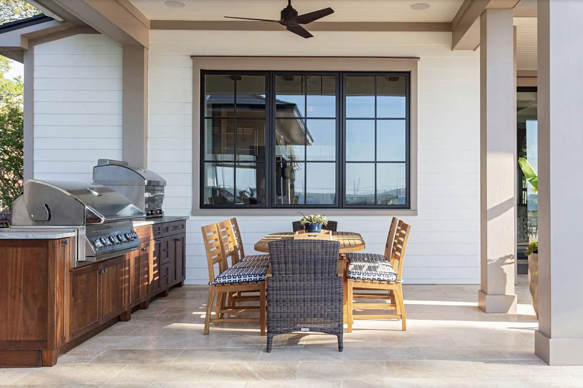 contemporary covered porch with a built-in grill and alfresco dining