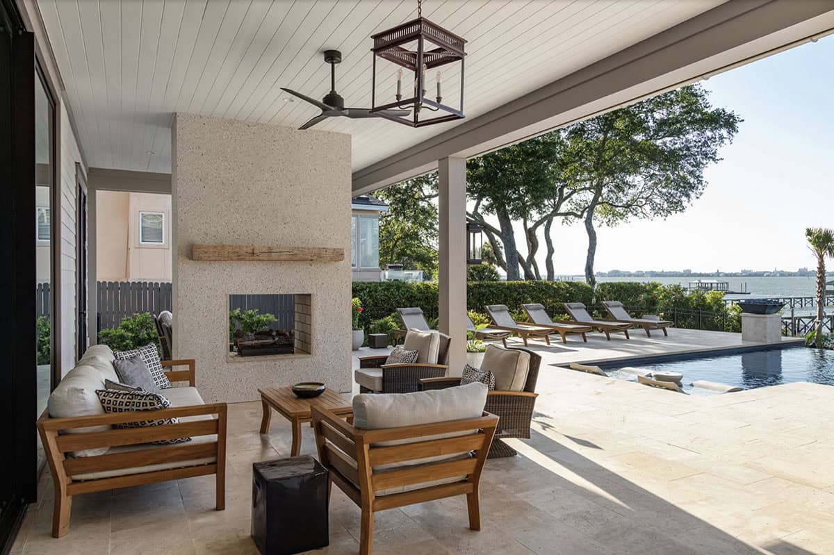 contemporary covered patio with outdoor furniture and a dual-sided fireplace