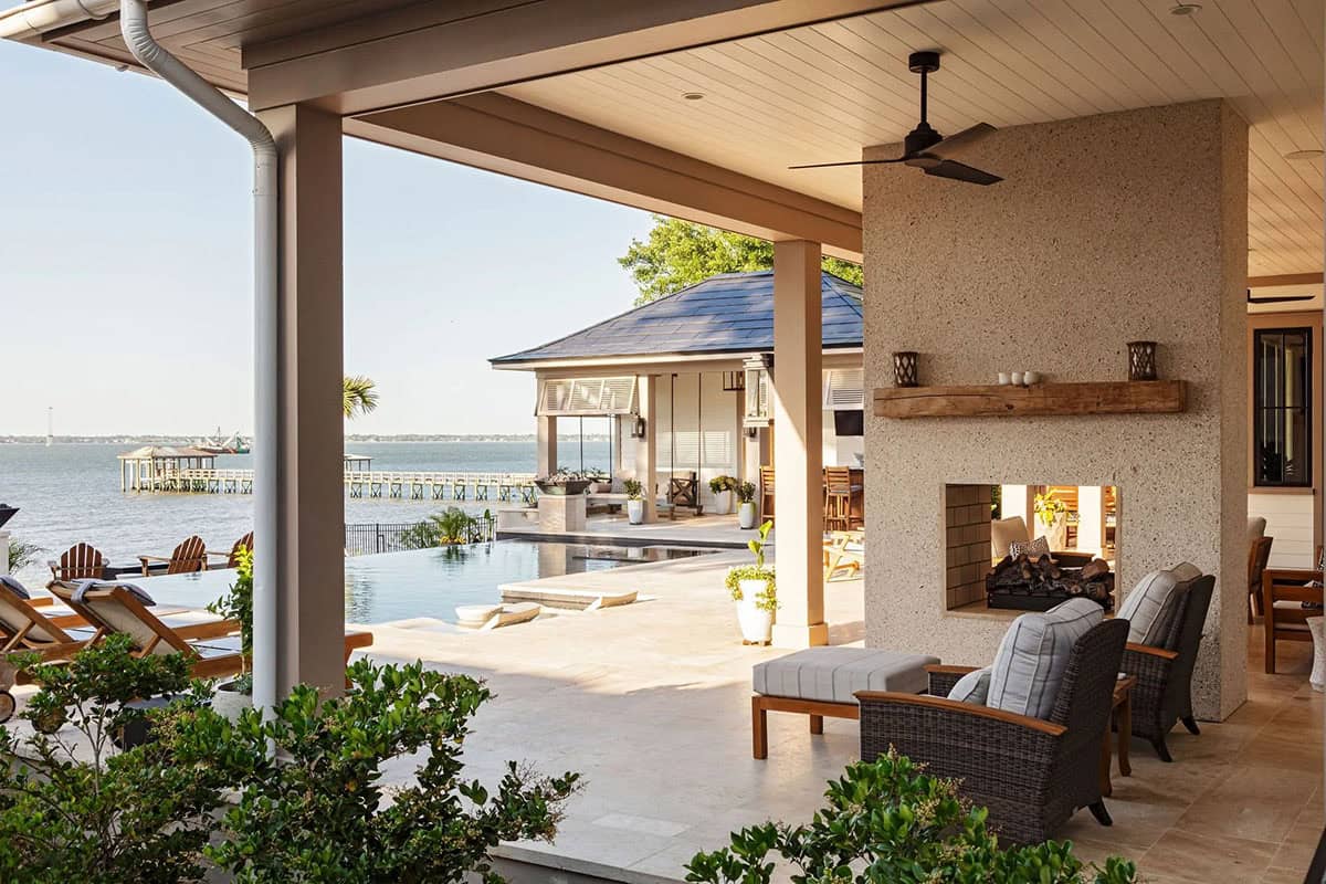 contemporary covered patio with outdoor furniture and a dual-sided fireplace