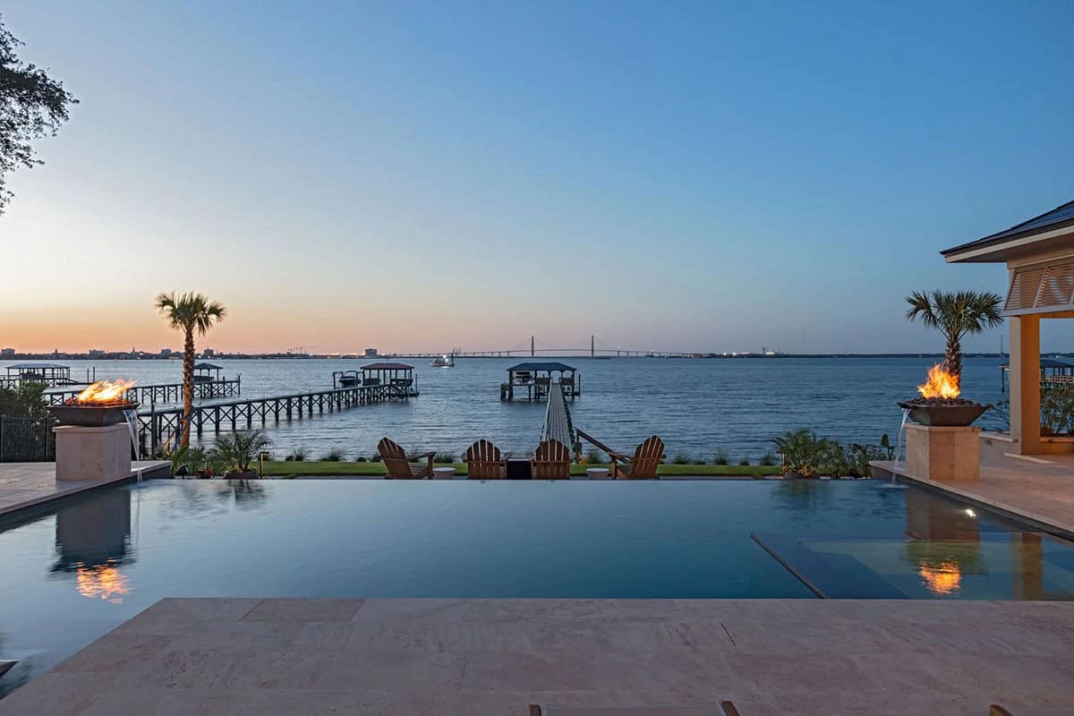 contemporary home exterior with a pool at dusk 