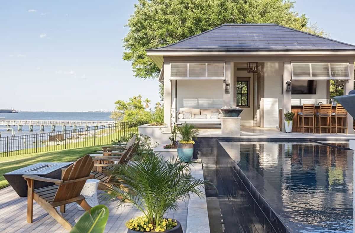 contemporary swimming pool with a pool house