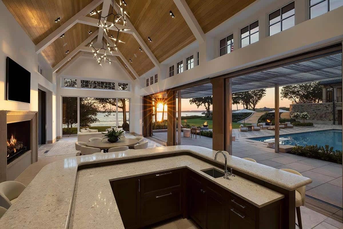 pool house with an outdoor kitchen and sitting area with a fireplace