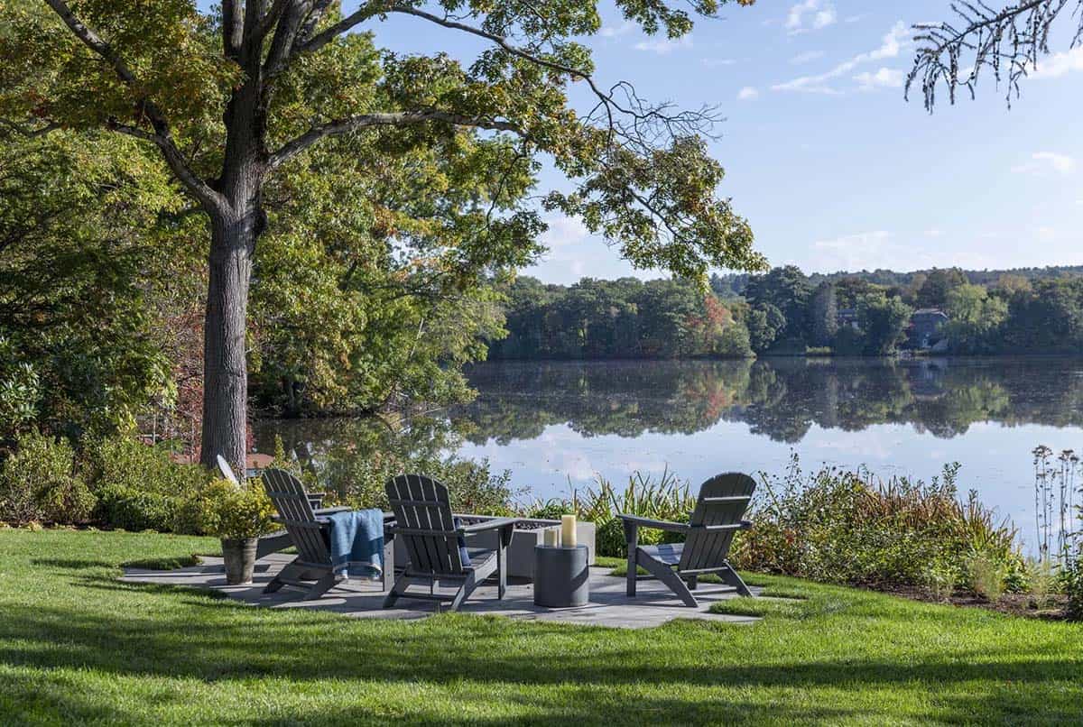 contemporary lake house patio with a fire pit and adirondack chairs