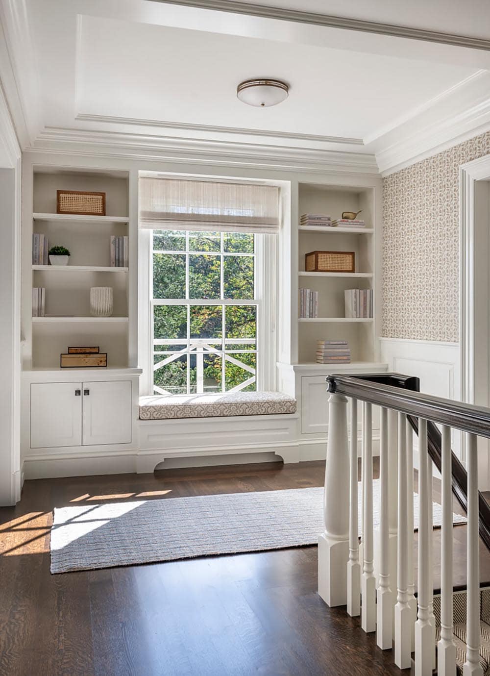 contemporary staircase landing with a window and built-in shelves