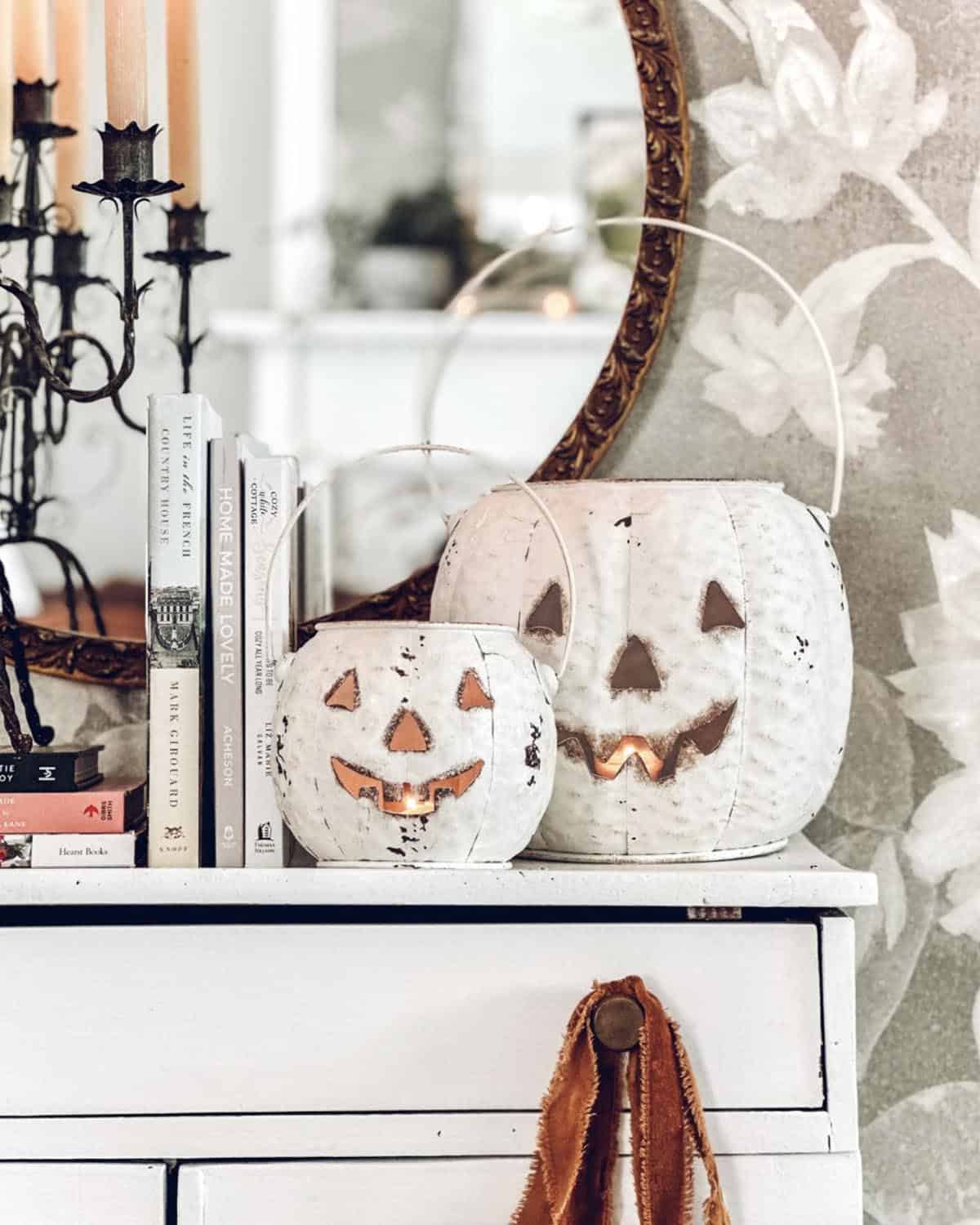  jack o lanterns on top of a dresser